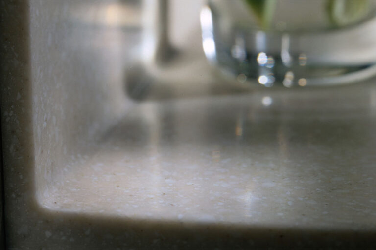 Bathroom vanity top with QuickFold coved backsplash